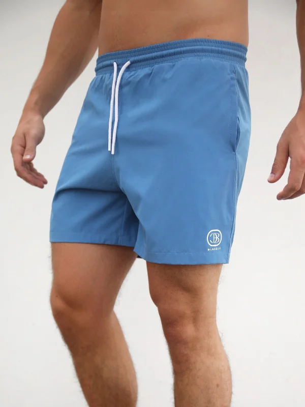 Men's ripped denim shorts for a trendy streetwear aesthetic Initial Swim Shorts - Light Blue Men's ripped denim shorts for a trendy streetwear aesthetic Initial Swim Shorts - Light Blue